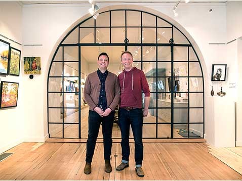 Business owners posing for a photo in the showroom